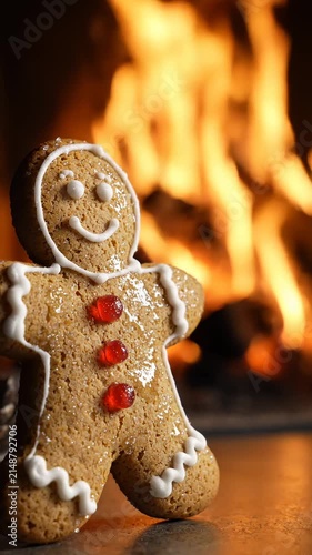 Gingerbread Man Cookie Standing in Front of a Warm Cozy Fireplace