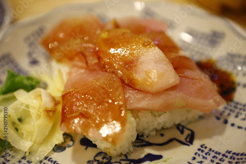 Принти на полотні Fresh raw fish nigiri sushi is served on a ceramic plate.