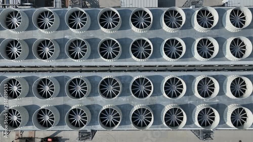 Top-down flyover of industrial cooling fans at a hyperscale AI data center showing large rooftop cooling infrastructure supporting cloud computing operations.