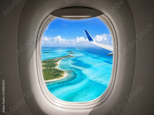 Tropical island view through airplane window seat