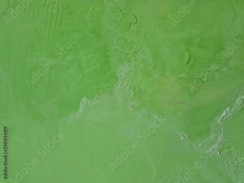 Close up of green concrete wall damaged by moisture and salt efflorescence