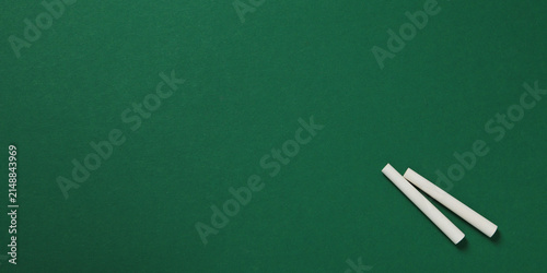 Back to school, Chalk pieces rest on green board ready for new school year
