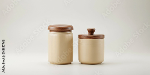 Two ceramic jars with wooden lids for kitchen storage on a white background