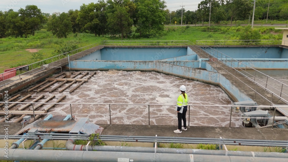 Fototapeta premium Drone aerial perspective of water treatment facility and industrial wastewater management basin. Environmental engineering, sanitation infrastructure and recycling process.