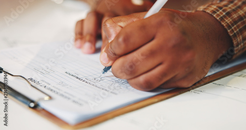 Konstfotografi Hands, writing and application form for insurance with clipboard, risk assessment and administration