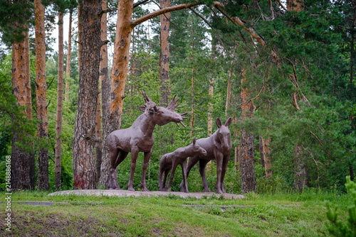 Wooden moose statues in the Prigorodny Forest Park in Tambov, Tambov region of Russia