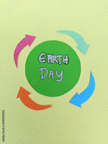 Earth Day symbol promoting recycling, sustainability and environmental awareness through colorful circular arrows and bold typography.