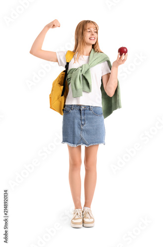 Female student with apple showing muscles on white background
