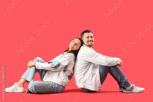 Happy young couple sitting ...