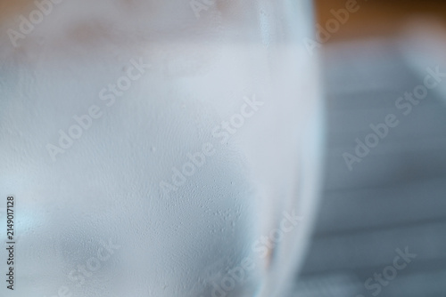 Fotografie Close-up of a cold glass filled with sparkling water and tiny condensation dropl