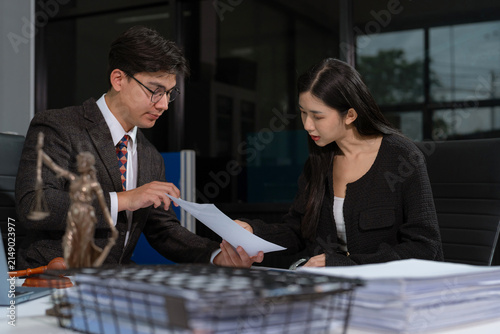 Lawyers review tablet chat messages during a defamation lawsuit, examining social media evidence, digital communication, and legal strategy.