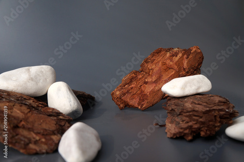 Photography Low angle stage setup crafted from raw tree bark slices and smooth stones