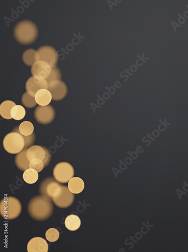 Golden Bokeh Light Particles Floating on Dark Background