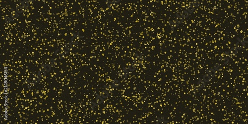 Foto Glittering gold particles scattered on a dark background luxury texture