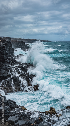 Turquoise Waves Crashing on Volcanic Rocks Coastal Scene