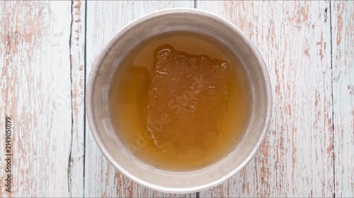 Timelapse: dissolution of fruit frozen juice, top view	