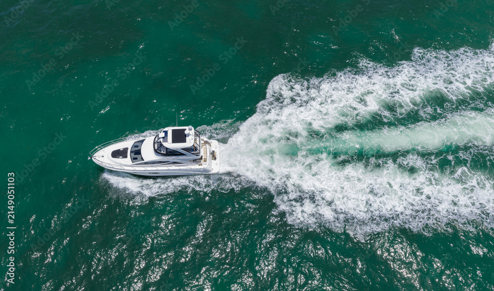 Naklejka premium Motorboat sailing at sea. Luxury private yacht in sea. Motor yacht luxury vessel. Boat motor aerial. Vacation on summertime. Aerial view motorboat. Yacht boat tour. Luxury boat yachting