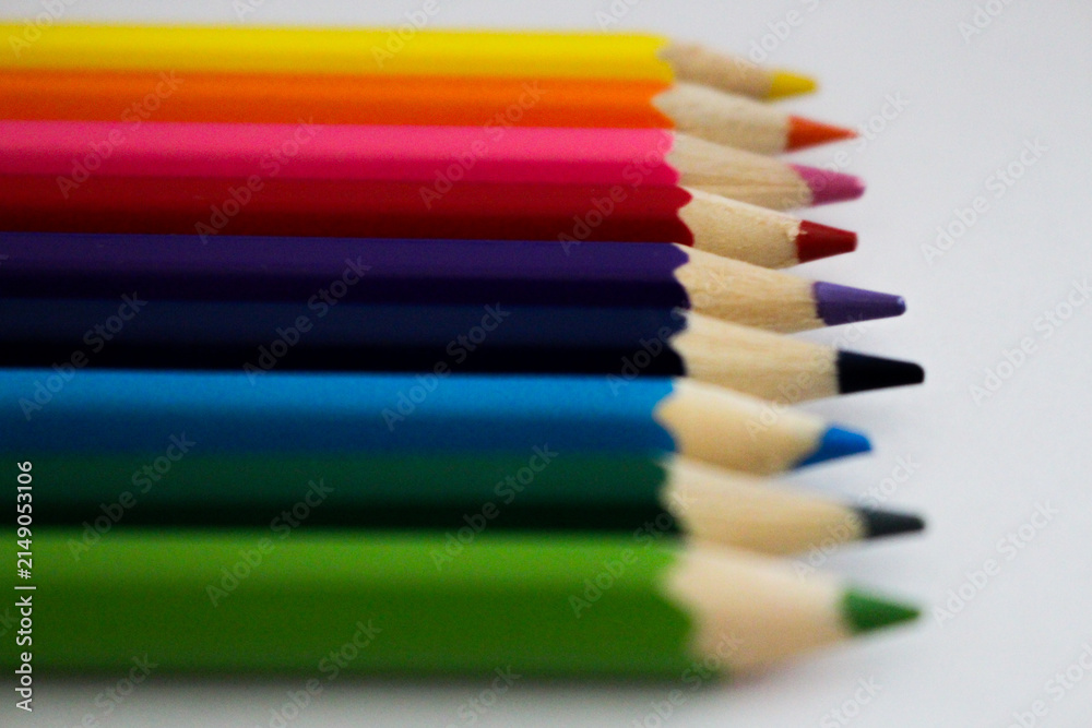 Fototapeta premium colored pencils in a row on white background