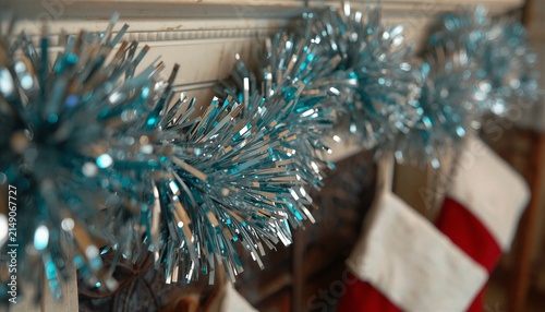 Vibrant Christmas fringe garland decoration close up, shiny winter holiday slinger wall ornament.
