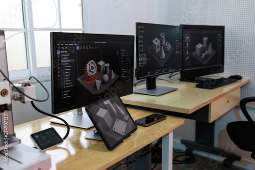 Obraz na plátne Modern workstation with multiple monitors 3d modeling software in an office lab