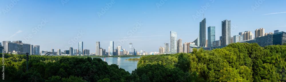 Fototapeta premium The scenery of Swan Lake in Hefei, Anhui Province, China. Xindi Center and Hefei Radio & Television Center Building stand in the distance, both being landmark buildings of Hefei.
