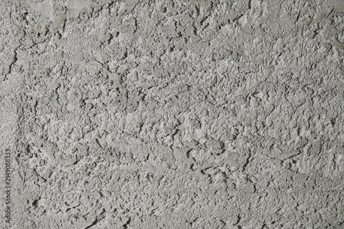 Textured Grey Wall Surface with Rough Finish and Uneven Patterns Highlighting Concrete Material