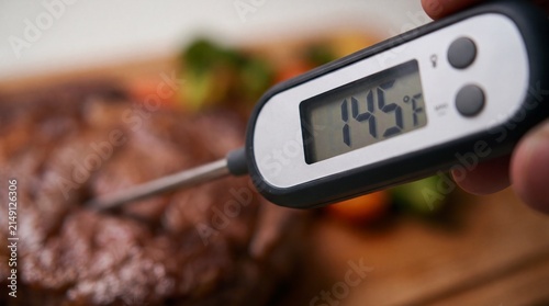 Perfect steak doneness verified with a digital meat thermometer before serving. Accurate temperature measurement ensures safe meals and confident home cooking.