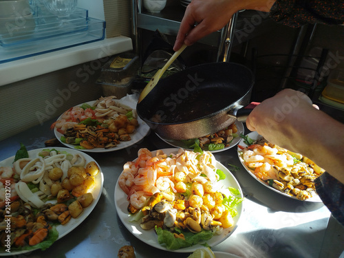 Chef preparing hot dish with vegetables in kitchen