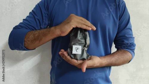 Closeup of person hand protecting Indian rupee money bag inside palm. Insurance of capital, deposits, business and savings accounts. Guaranteed payments protection and financial security concept.