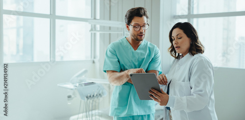 Discussion between dental colleagues continues with tablet review in the clinic