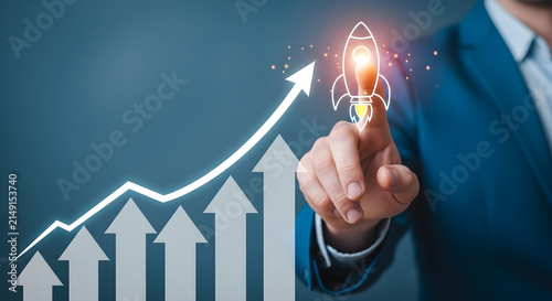 Businessman touching a glowing rocket icon to symbolize business growth and upward financial success strategy with a digital upward trend chart