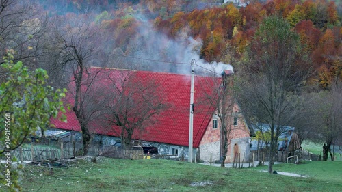 Smoke rising out of a farm house in the village of Theth in Albania