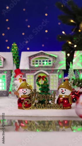 An unusual Santa Claus appears in front of the Christmas town