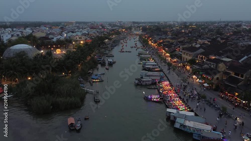 Tourists enjoying boat rides with colorful lanterns on the thu bon river in hoi an's ancient town
