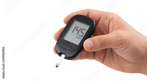 Hand holding glucose meter with elevated reading