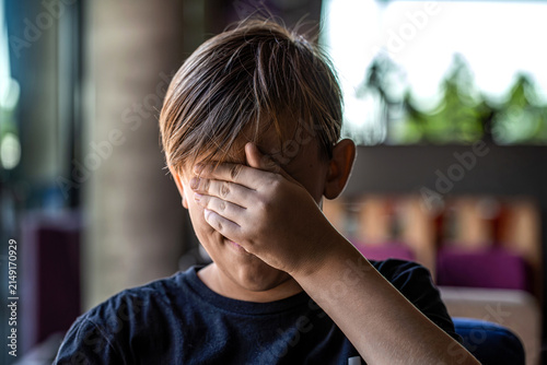 Fear children hand cover face. Boy covering face with hands. Children's bullying, unhappy kid boy hands hides his face. Sad offended child boy. Child abuse. Violence, domestic problem in family