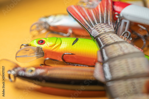 Obraz na plátne Close up of segmented swimbait lure with green wobbler in background The Concept