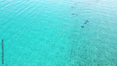Top down aerial view of crystal clear turquoise sea water texture background