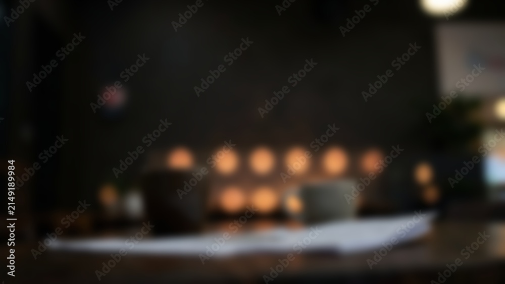 Obraz premium blurred dark workspace table with warm bokeh for financial