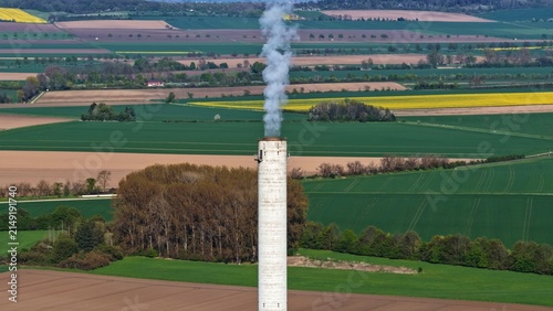 Konstfotografi Industrial Chimney with Vapor Plume above Agricultural Landscape