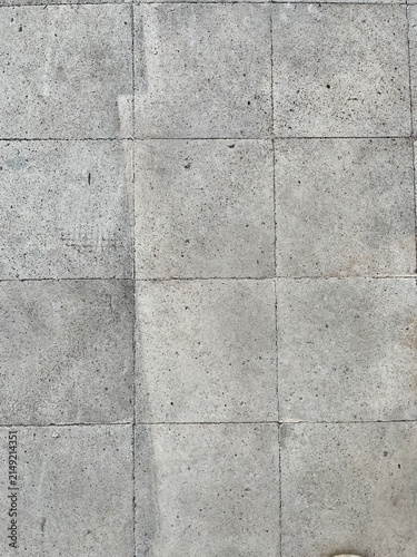 Grungy weathered grey concrete floor tiles texture background with rough stained stone surface pattern and grout lines