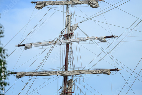 Bild auf Leinwand Tall ship mast with folded sails and rigging lines.