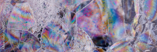 High-detail texture image of shimmering soap bubbles and membranes — vibrant, geometric, and visually striking.