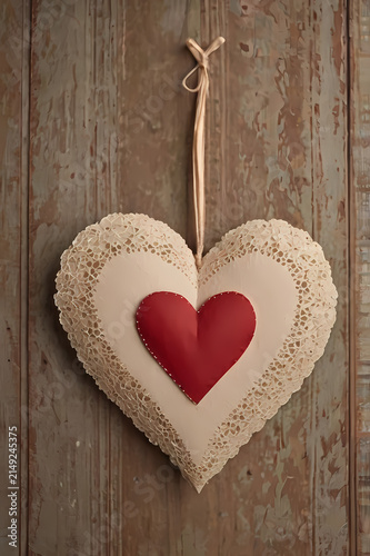 Hanging layered white and red handmade paper heart on rustic wooden background with romantic styling
