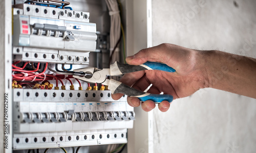Canvas Print Certified Electrician Servicing Electrical Distribution Panel for Safe and Relia