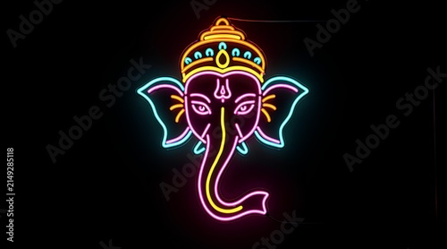 Vibrant neon depiction of Lord Ganesha, the Hindu elephant-headed deity, illuminated on a dark background for festive and