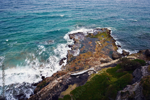 Land entering the sea at the Pacific ocean, under Sea cliff bridge.