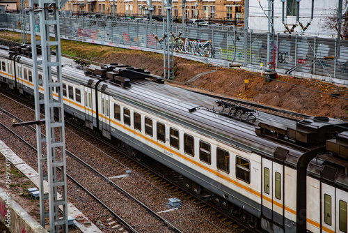 Fotografie A passenger electric train on the railway tracks in the city