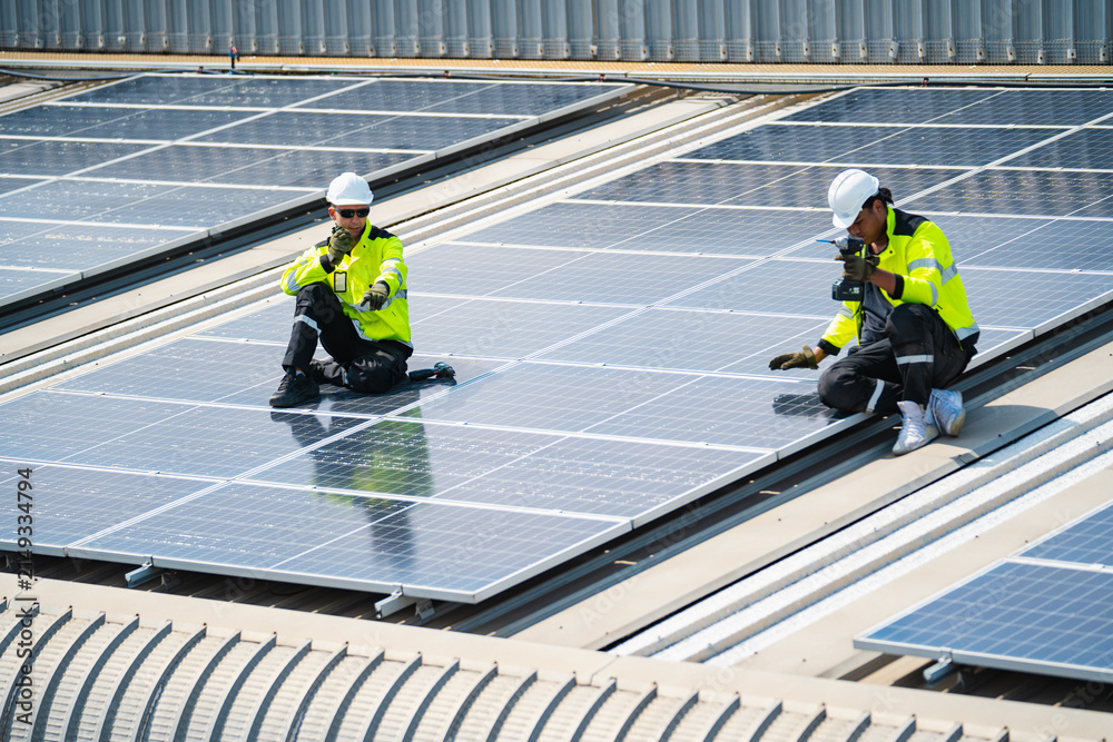 Fototapeta premium Solar electricity power technology for sustainable energy, solar panel worker roof safety helmet reflective vest inspection renewable energy maintenance photovoltaic technician inspecting rooftop