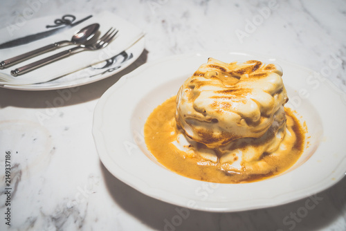 Flambe Bombe Alaska Layered meringue ice-cream cake with flambe rum